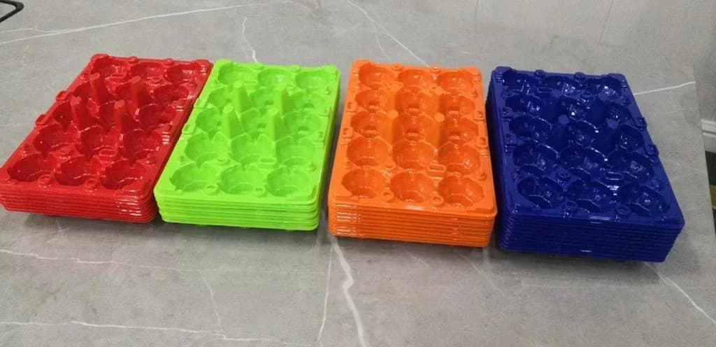 15-egg trays stacked in red, green, orange and blue