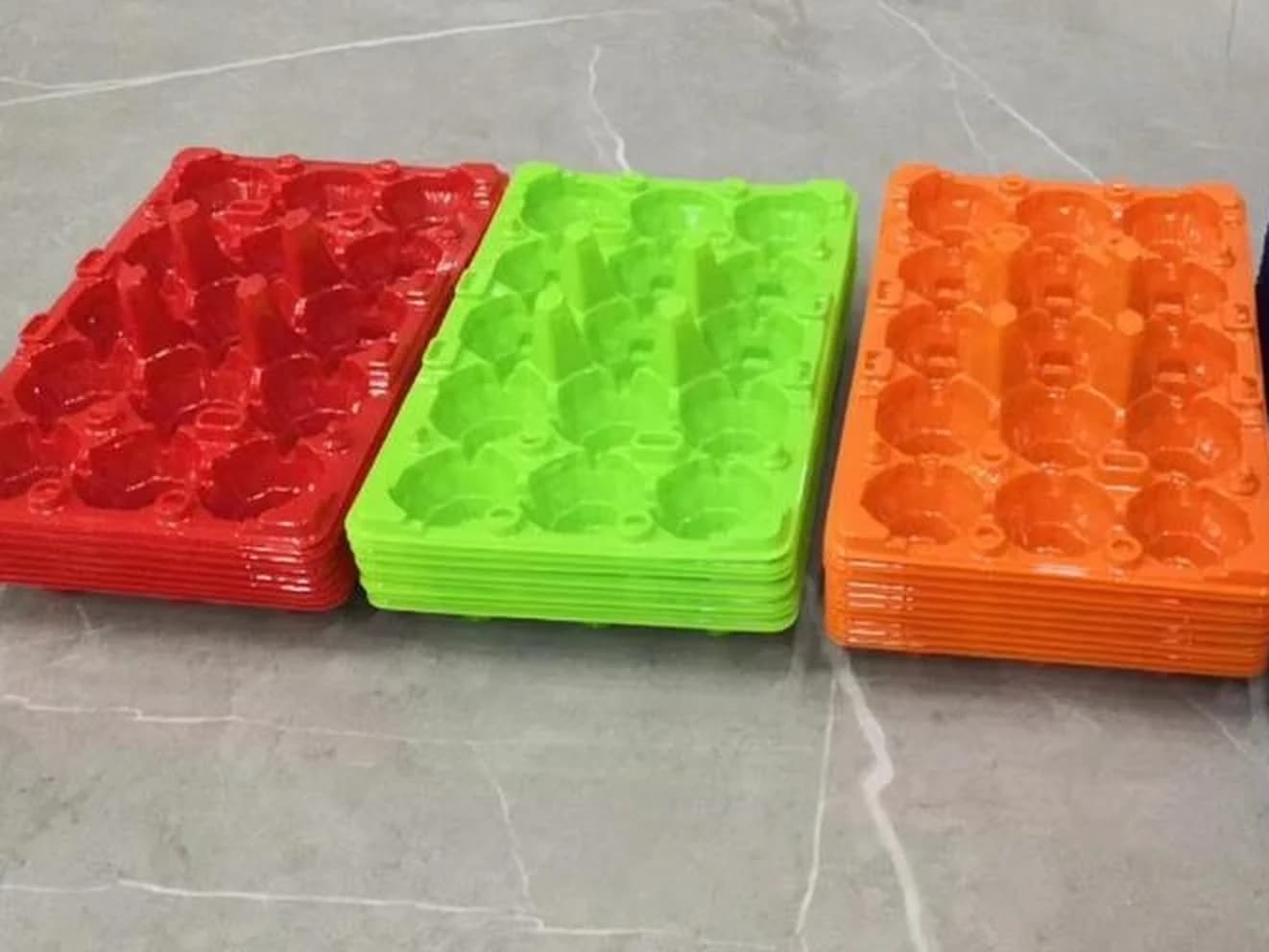 15-egg trays stacked in red, green and orange